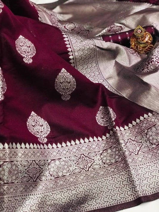 Maroon Banarasi silk saree with silver zari work and intricate floral motifs