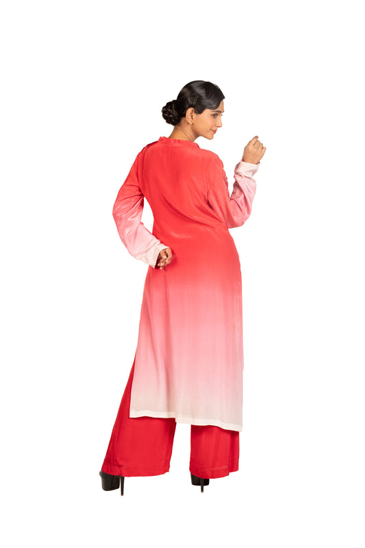 Woman wearing red ombre kurta set with palazzo pants on white background
