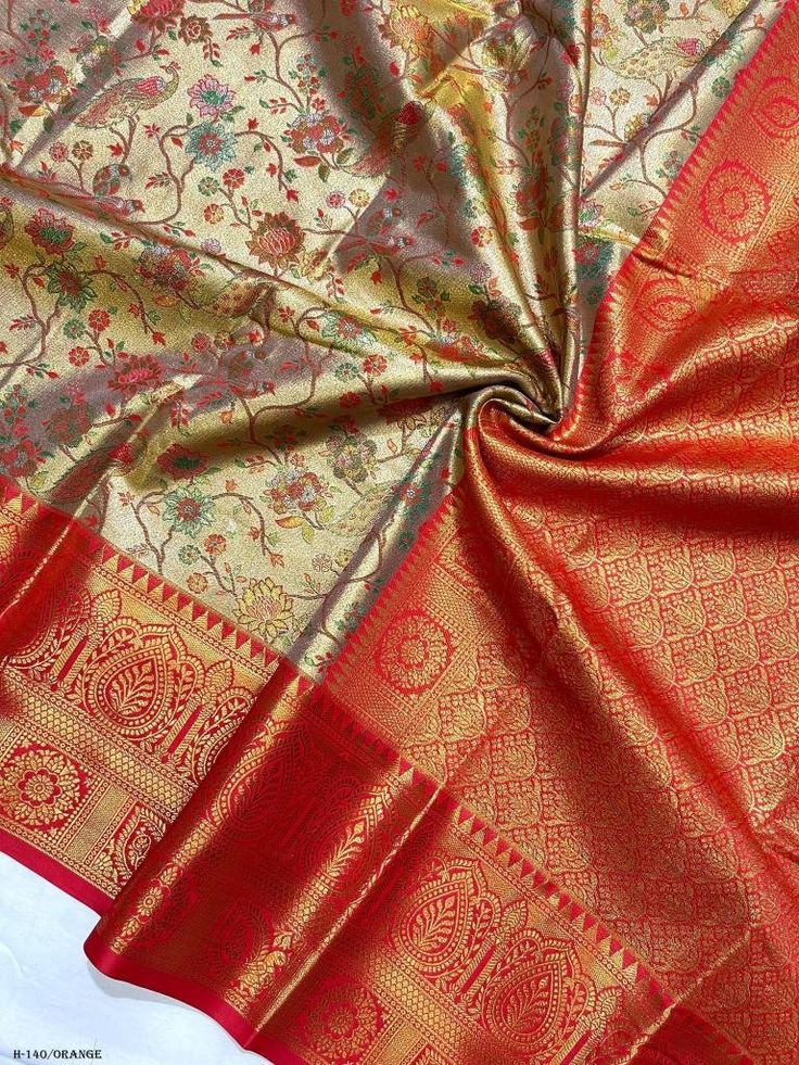 Traditional Dharmavaram saree with gold zari floral design and red orange border